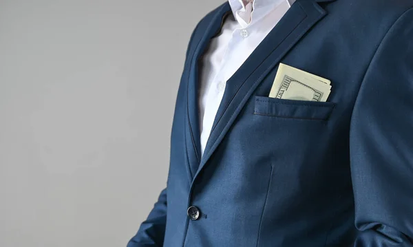 man in suit puts money in his pocket, corruption concept . High quality photo