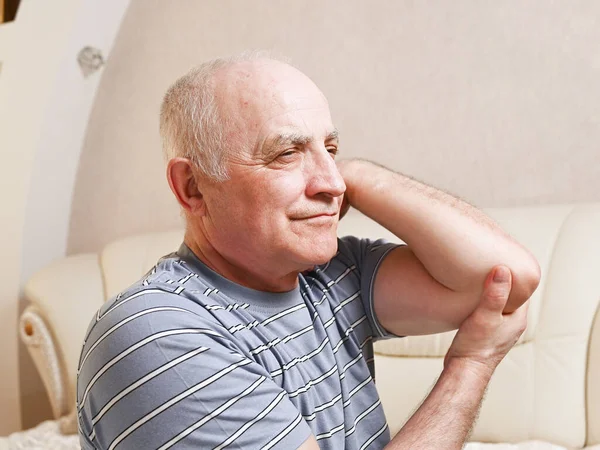 elderly man with pain in his arm.