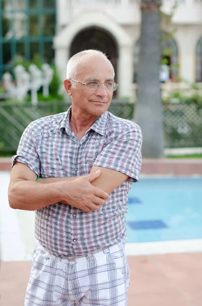 Portrait of a yellow man against the background of a pool.