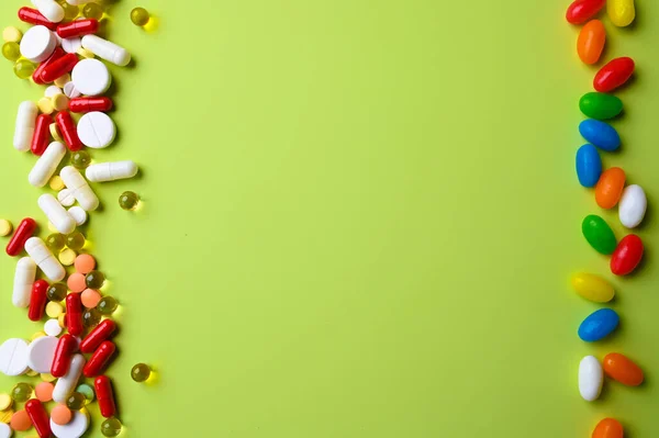 Top view of colorful bright pills and vitamins on pastel green background — Stock Photo, Image