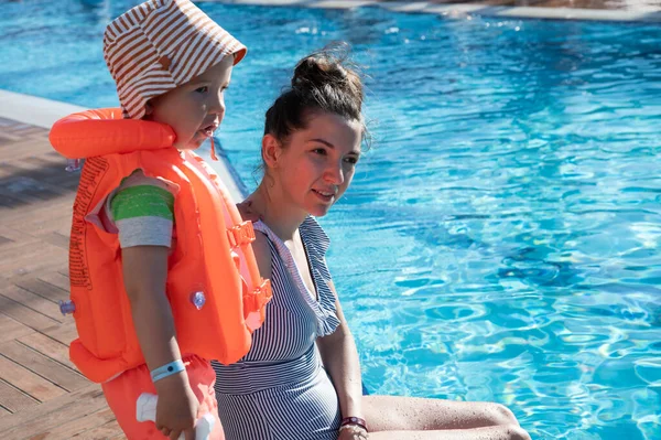 Child in a life jacket near the pool — Stock Photo, Image