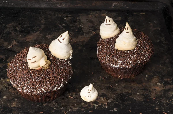 Chocolate pumpkin cupcake, decorated with meringue ghosts Stock Photo