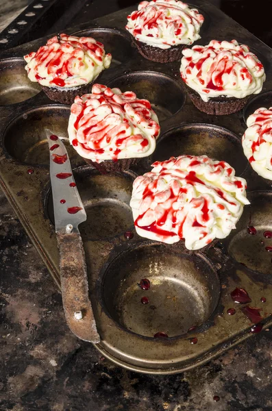 Chocolate pumpkin cupcake, decorated with icing in shape of brain Stock Picture