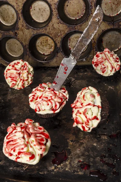Chocolate pumpkin cupcakes, decorated with icing in shape of brain Stock Image