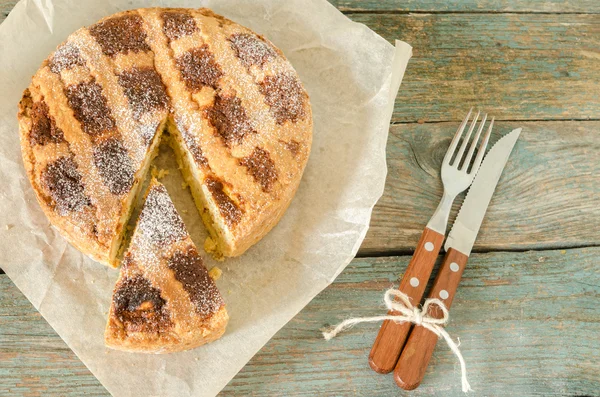 Neapolitan pie on wrapping paper — Stock Photo, Image