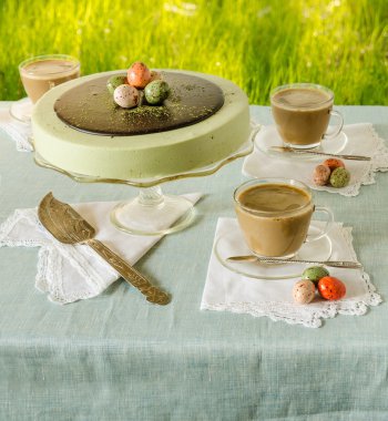 Paskalya tabloda çay matcha yeşil çim zemin üzerine cheesecake ve beyaz kahve ile