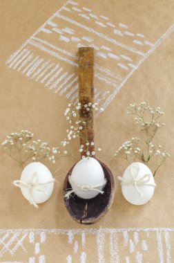 Easter still life with old wooden spoon, eggs and flowers. clipart