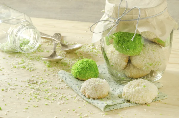 Sugar cookies with coconut flakes in glass jar — Stock Photo, Image