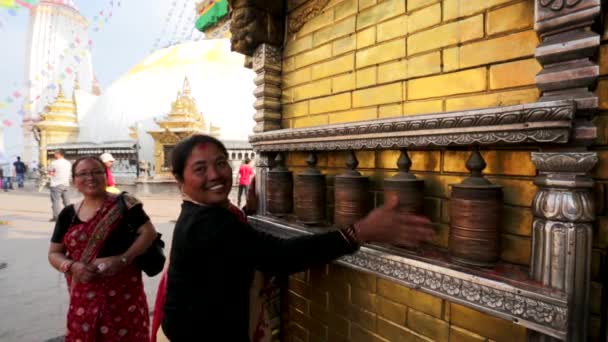 Women spin buddhist prayer wheels — Stock Video