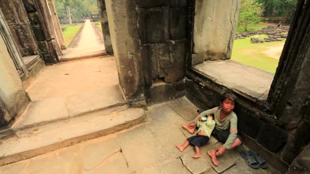 Cambodian boy holding a baby — Stock Video