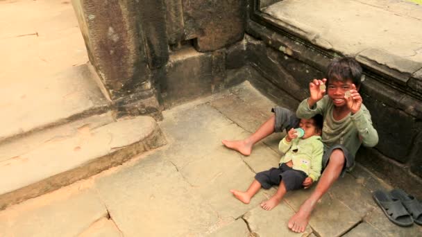 Cambodian boy holding a baby — Stock Video