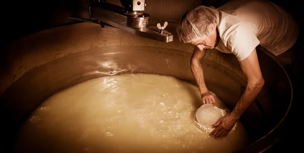 Cheesemaker-Traditional cheese making at a creamery , — стоковое фото