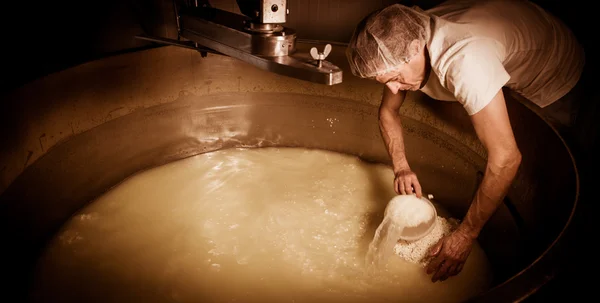 Cheesemaker-Traditional cheese making at a creamery , — стоковое фото