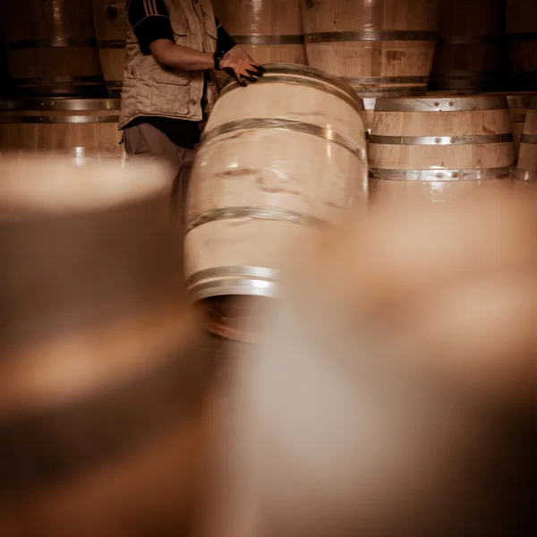 Winemaker barrels moving up or down by rolling on ground — Stock Photo, Image