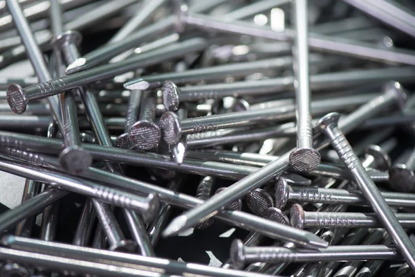 Carpenter long nails on a table — Stock Photo, Image