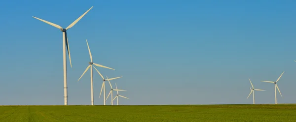 Windmills for electric power production on blue sky — Stock Photo, Image