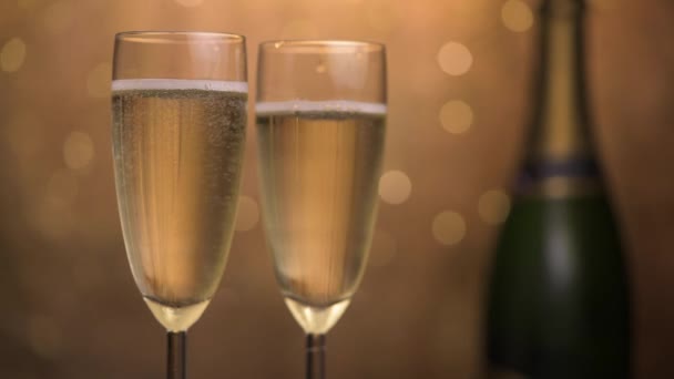 Champagne glasses over holiday bokeh blinking background, rotating on turntable, glasses with sparkling wine, celebration, party — Stock Video