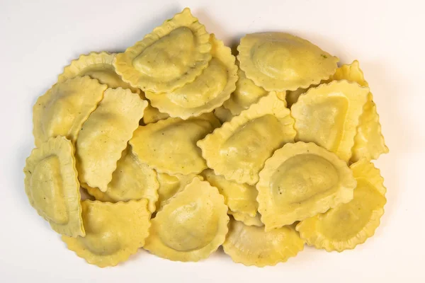 Ravioli cru saboroso com farinha e espinafre sobre fundo branco, processo de fazer ravioli italiano — Fotografia de Stock