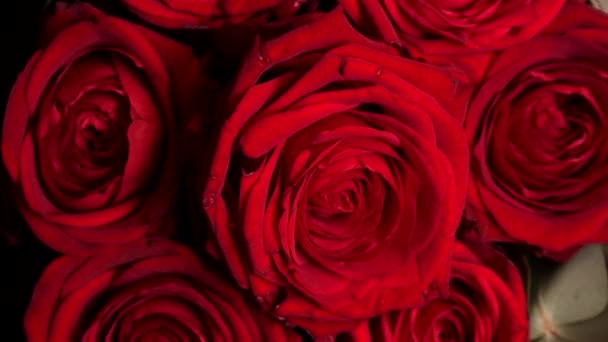 Нежный красочный букет красных роз на поворотном столе, крупным планом — стоковое видео