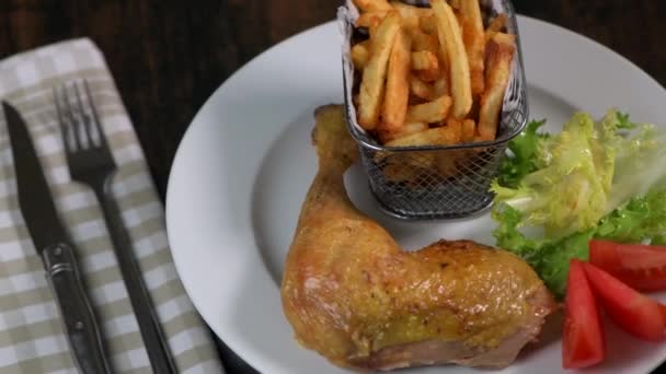 Roasted dinner on white plate containing chicken and potato, homemade fries — Stock Video