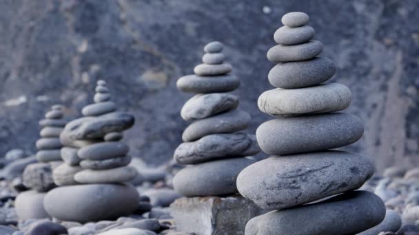 Rock stack balance and harmony on sea beach with evening ambient light — Stock Video