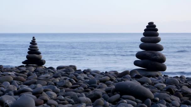 Rock stack balance and harmony on sea beach with evening ambient light — Stock Video