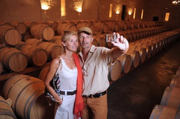 Tourism-Couple visiting a castle photographing in a barrel cella — Stock Photo, Image