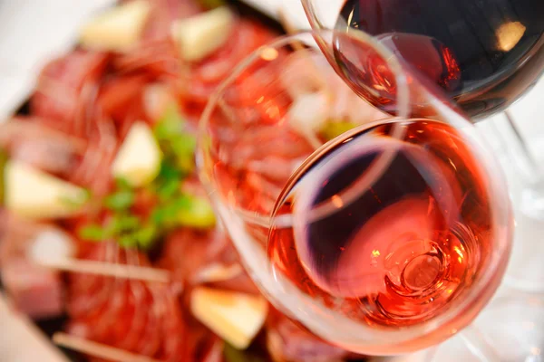 Red and Pink glass of wine with delicatessen