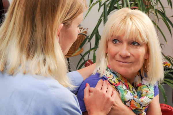 Senior woman with her home caregive — Stock Photo, Image