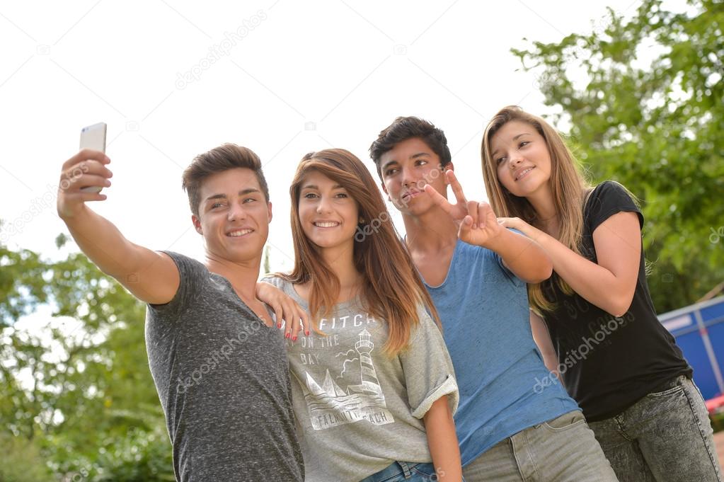 Cheerful teenager friends taking selfie