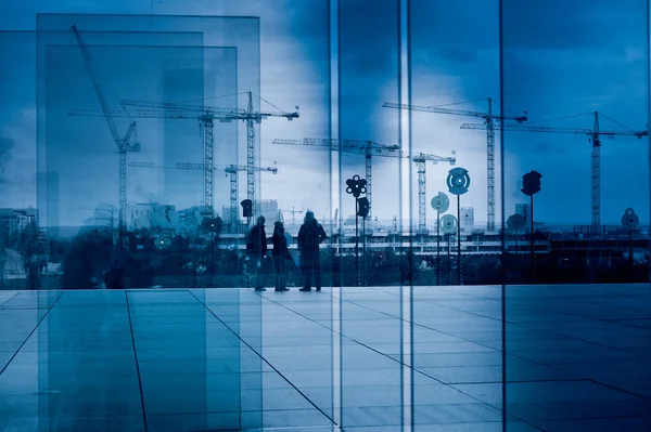 Silhouette of a crane group through glass blocks — Stock Photo, Image