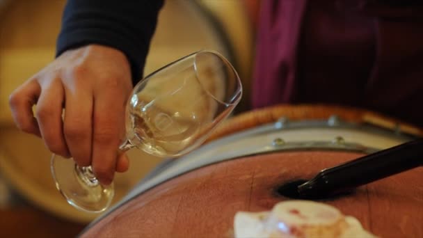 Winemaker in cellar making wine test. — Stock Video