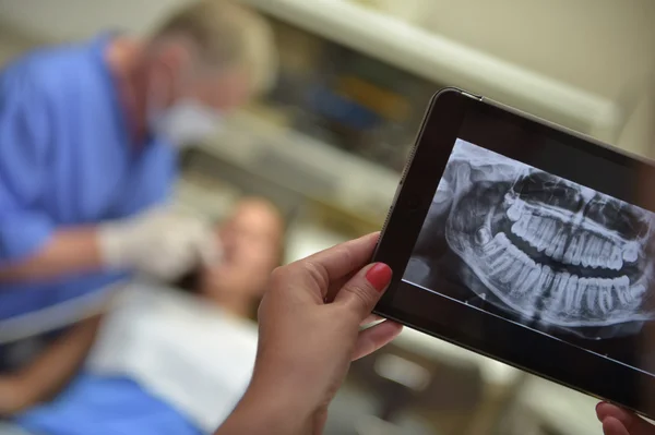 Diş hekimi Office dijital tablet bir hasta x-ışınları ile