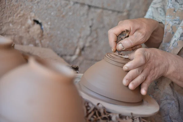Um artesão marroquino joga um pote de barro em uma roda de oleiros . — Fotografia de Stock