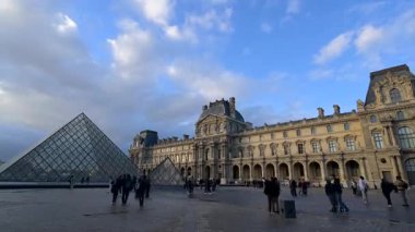 Paris, Fransa - Ekim 04: 2025: Paris 'teki ünlü Louvre Müzesi muhteşem günbatımı gökyüzüne karşı ikonik cam piramitlerini sergiliyor