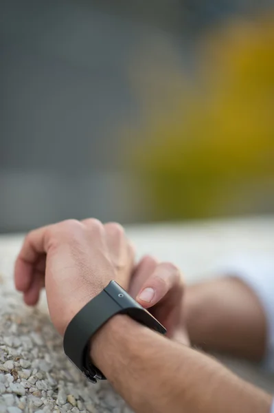 Man with Mobile phone connected to a smart watch