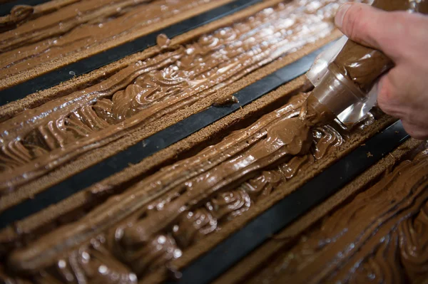 Pastelaria em sua oficina preparando registros de chocolate Yule — Fotografia de Stock