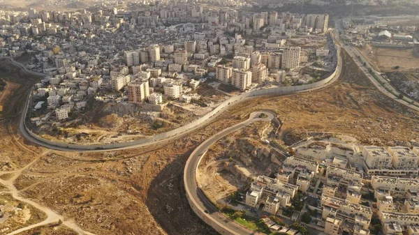 Israel and Palestine divided by Security wall Aerial viewAerial view of Left side Anata Palestinian town and Israeli neighbourhood Pisgat zeev