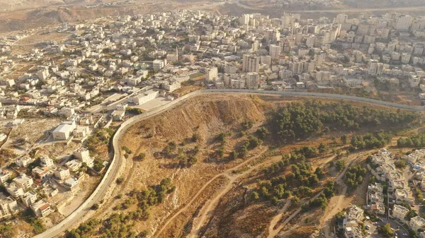 Israel and Palestine divided by Security wall Aerial viewAerial view of Left side Anata Palestinian town and Israeli neighbourhood Pisgat zeev