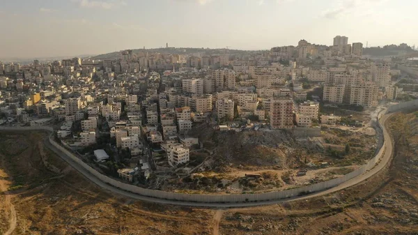 Israel and Palestine divided by Security wall Aerial viewAerial view of Left side Anata Palestinian town and Israeli neighbourhood Pisgat zeev