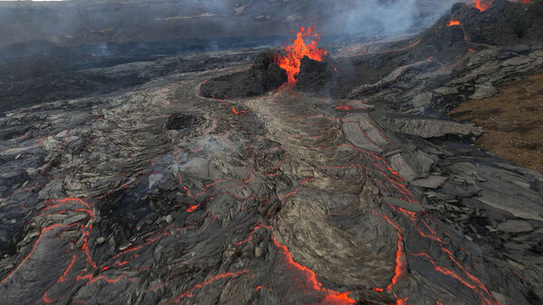 lava eruption volcano with snowy mountains, Aerial viewHot lava and magma coming out of the crater, April 2021 