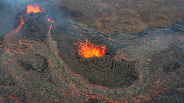 lava eruption volcano with snowy mountains, Aerial viewHot lava and magma coming out of the crater, April 2021 