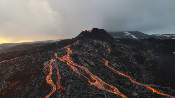 lava eruption volcano with snowy mountains, Aerial viewHot lava and magma coming out of the crater, April 2021 