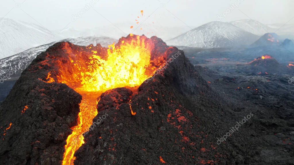 lava eruption volcano with snowy mountains, Aerial viewHot lava and magma coming out of the crater, April 2021 