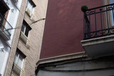 Panoramic view of the historic Bib-Rambla Square in Granada, Spain, featuring outdoor cafes, shops, and the characteristic atmosphere of the city center. Perfect image for concepts of tourism, urban life, culture, and Andalusian architecture.