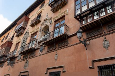 Panoramic view of the historic Bib-Rambla Square in Granada, Spain, featuring outdoor cafes, shops, and the characteristic atmosphere of the city center. Perfect image for concepts of tourism, urban life, culture, and Andalusian architecture.