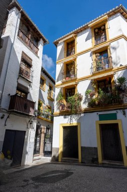 Details of the traditional architecture of Granada, southern Spain. Colorful facades, decorated balconies, and Moorish style reflect the Andalusian and Arabic influence of the city. Perfect image for travel, culture, history, and tourism concepts in 