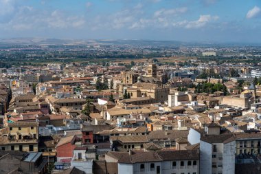 Aerial view of the city of Granada, Spain, showcasing the historic center, the Cathedral, the Alhambra, and characteristic Andalusian neighborhoods. Perfect image for urban landscape, tourism, culture, and architecture concepts.
