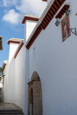 Exterior view of the Monastery of Santa Isabel la Real in Granada, Spain, featuring historic Andalusian architecture and a religious atmosphere. Perfect image for concepts of history, culture, religion, tourism, and architectural heritage.