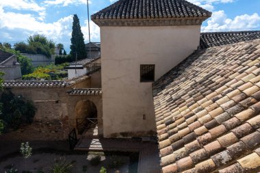 Aerial/panoramic view of traditional rooftops in Granada, in the Albaicn neighborhood, featuring terracotta tiles, urban geometries and typical Andalusian light play. Ideal image for projects about culture, travel, urban landscape, 